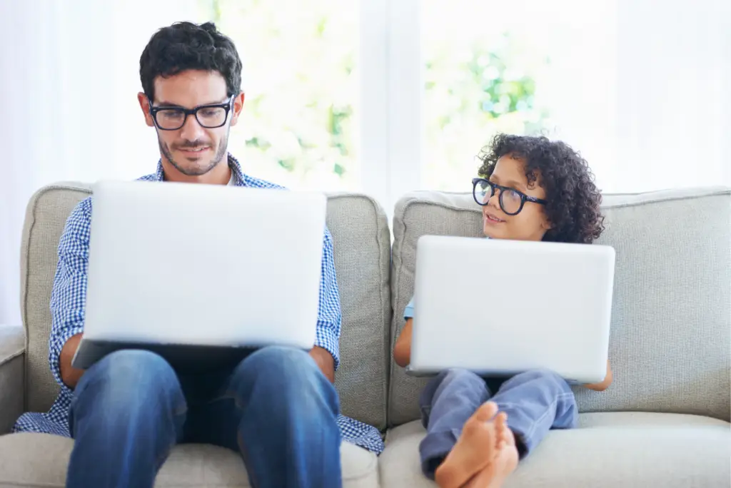 GetMeCoding photo of dad and son wearing glasses while working on a computer